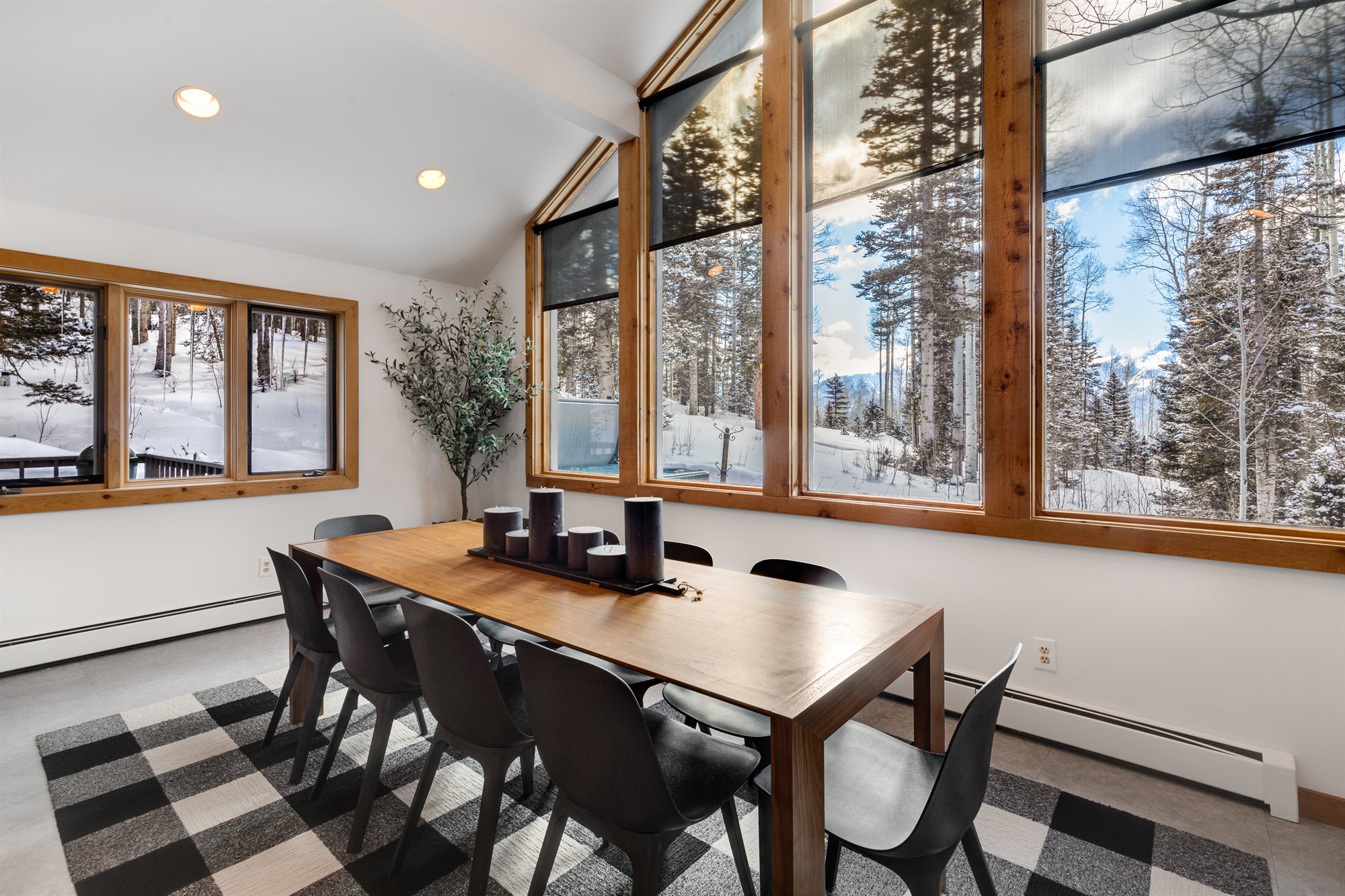 The dining table from the opposite end, looking back toward the windows