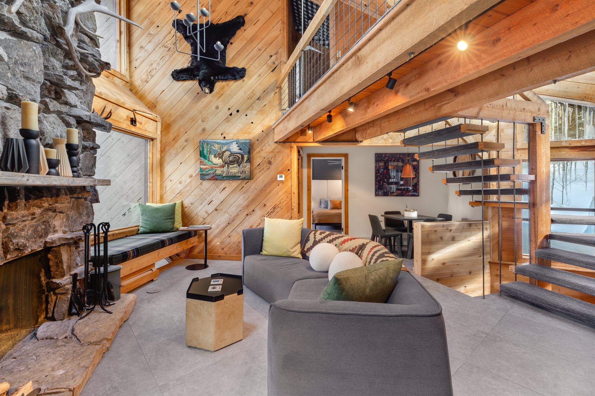 The Great Room at Black Bear Lodge, with stone fireplace and vaulted timber ceiling