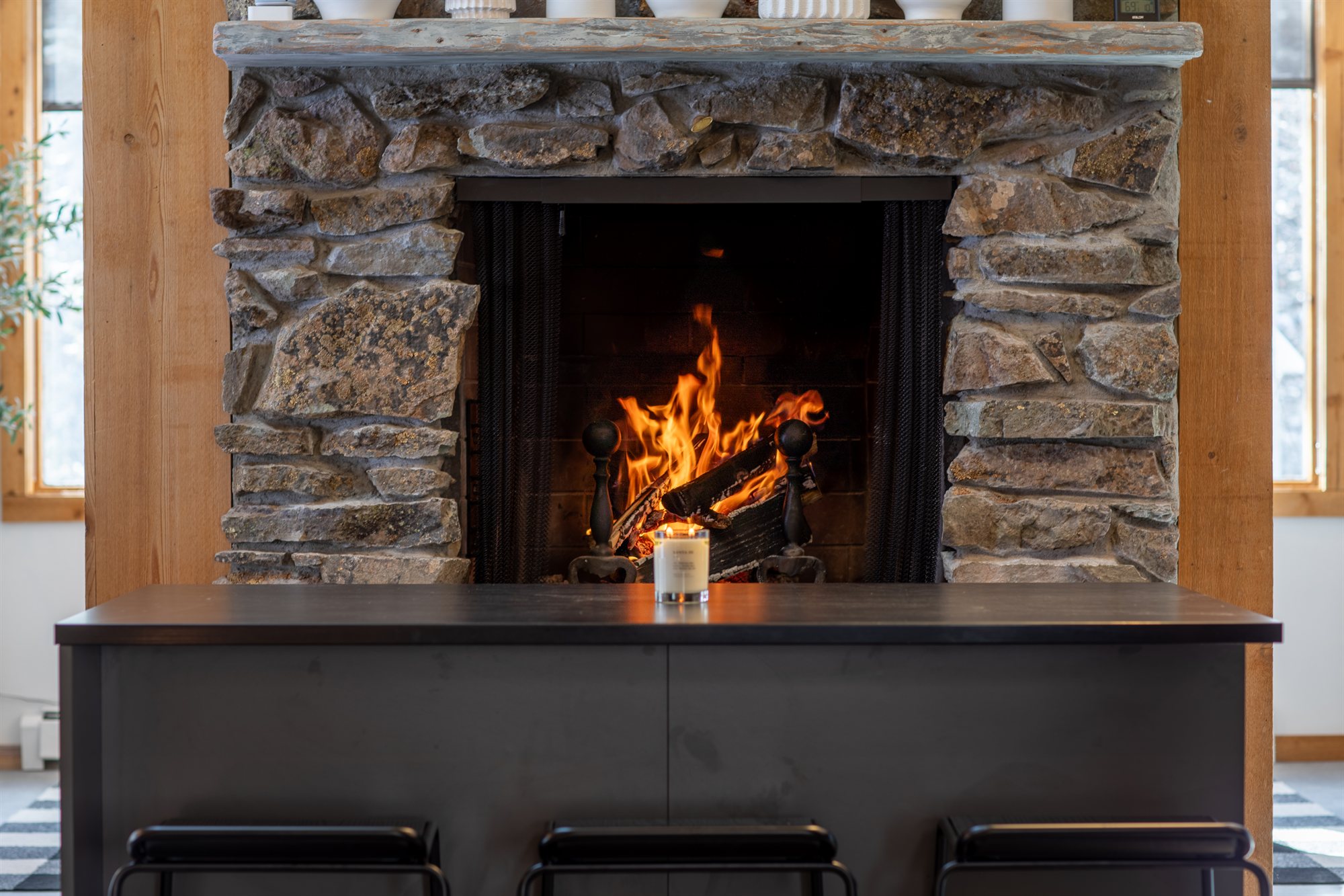 Fire burning in the kitchen's stone fireplace