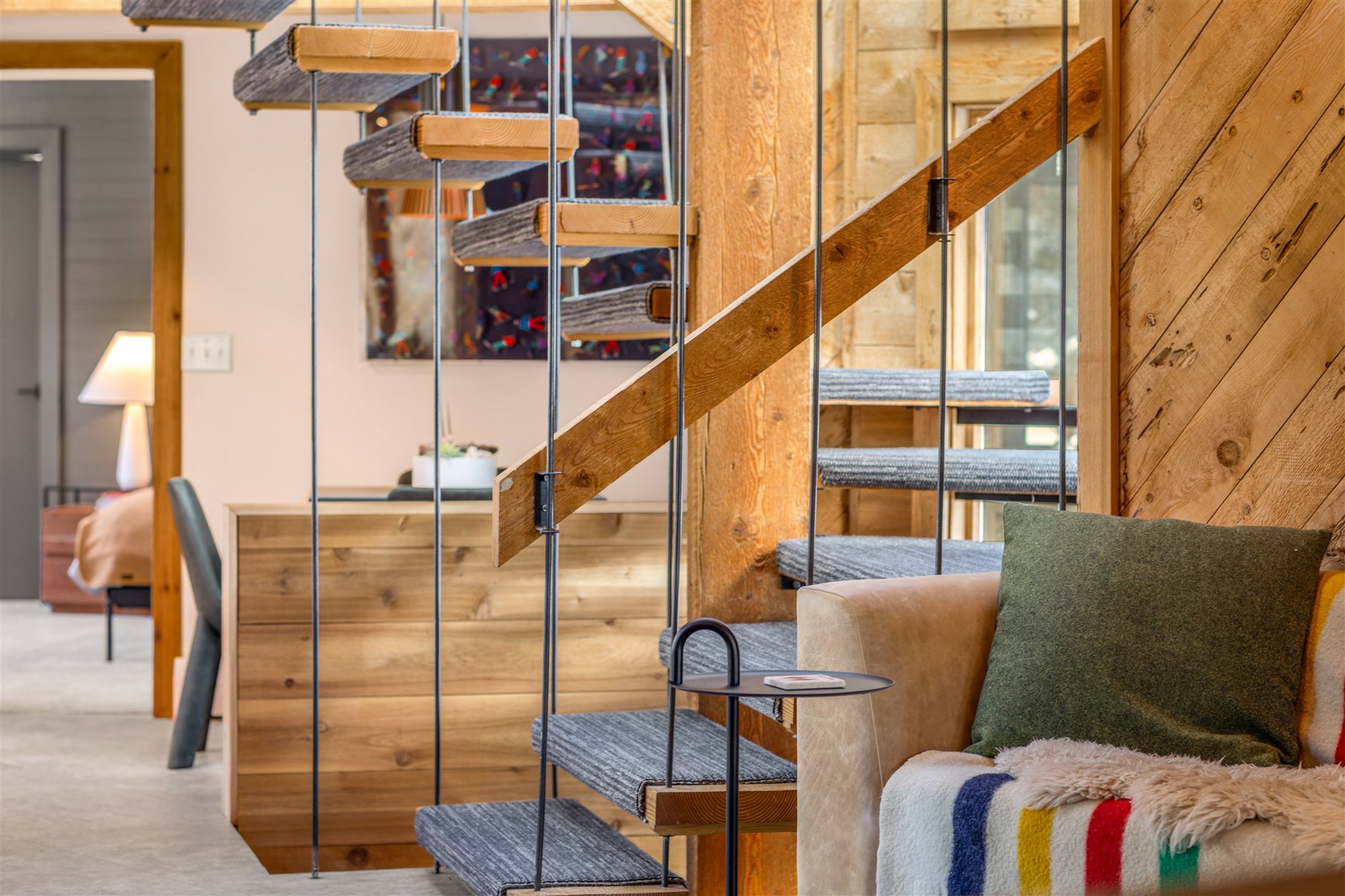 Timber stair rising to the loft under a skylight
